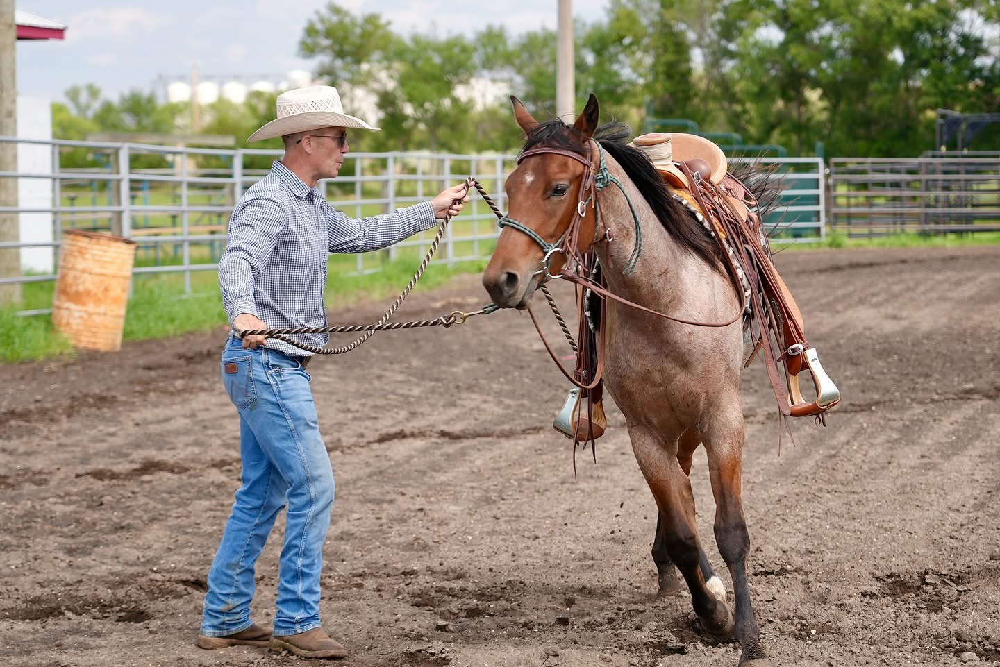Cody Robbins leading his rodeo horse around an arena