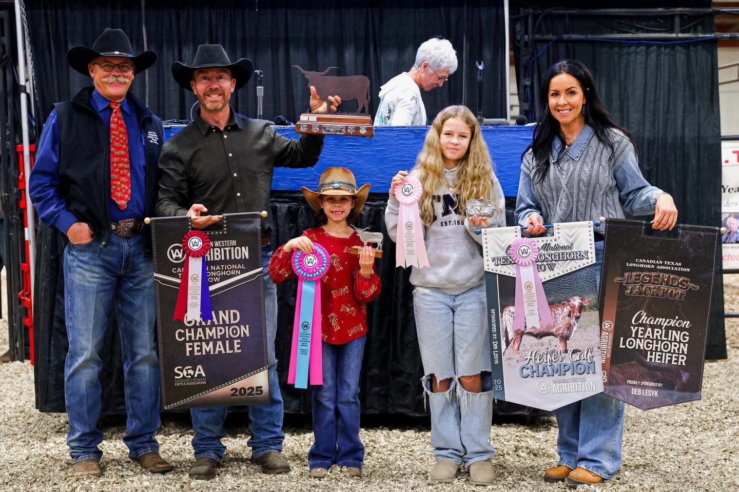 The Robbins' Family holding their ribbons and signs from their success at the Canada National Texas Longhorn Show