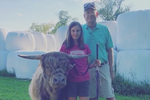 Young Heather Leading a Highland Bull with her Father Peter