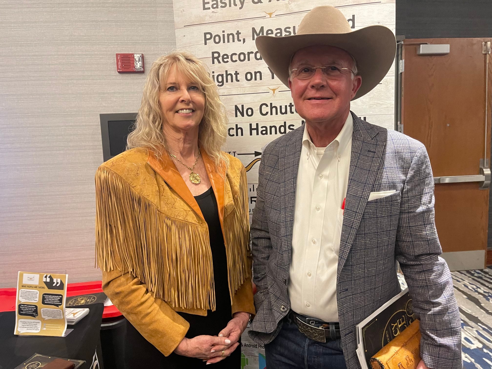 Hired Hand customer and Legacy Sale Co-Host Ann Gravett, G&G Longhorns with Auctioneer, Bruce McCarty.