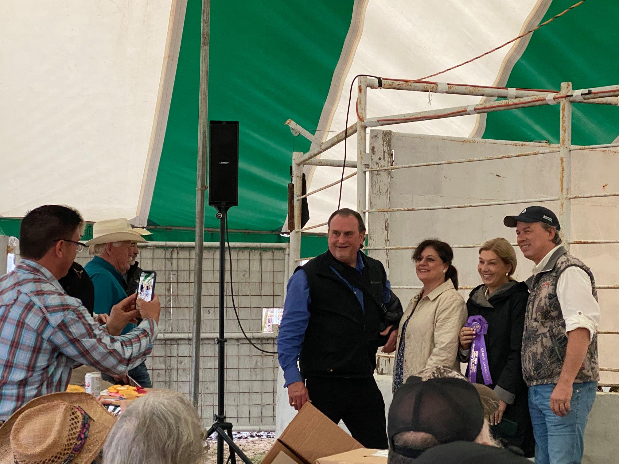 Hired Hand customers Russell Fairchild, Fairchild Longhorn Enterprises, taking a photo of Rex & Sherese Glendenning, Glendenning Farms and Holly & Mike Davis, Lucky Mountain Ranch.